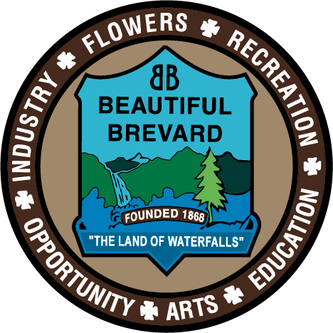 Logo for Beautiful Brevard showing a badge in the center with Beautiful Brevard verbiage and mountains artwork surrounding by a circle with text in it saying Recreation, Flowers, industry, opporunity, arts and, education.
