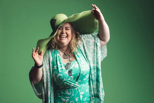 Keturah Allgood smiles in large green hat.